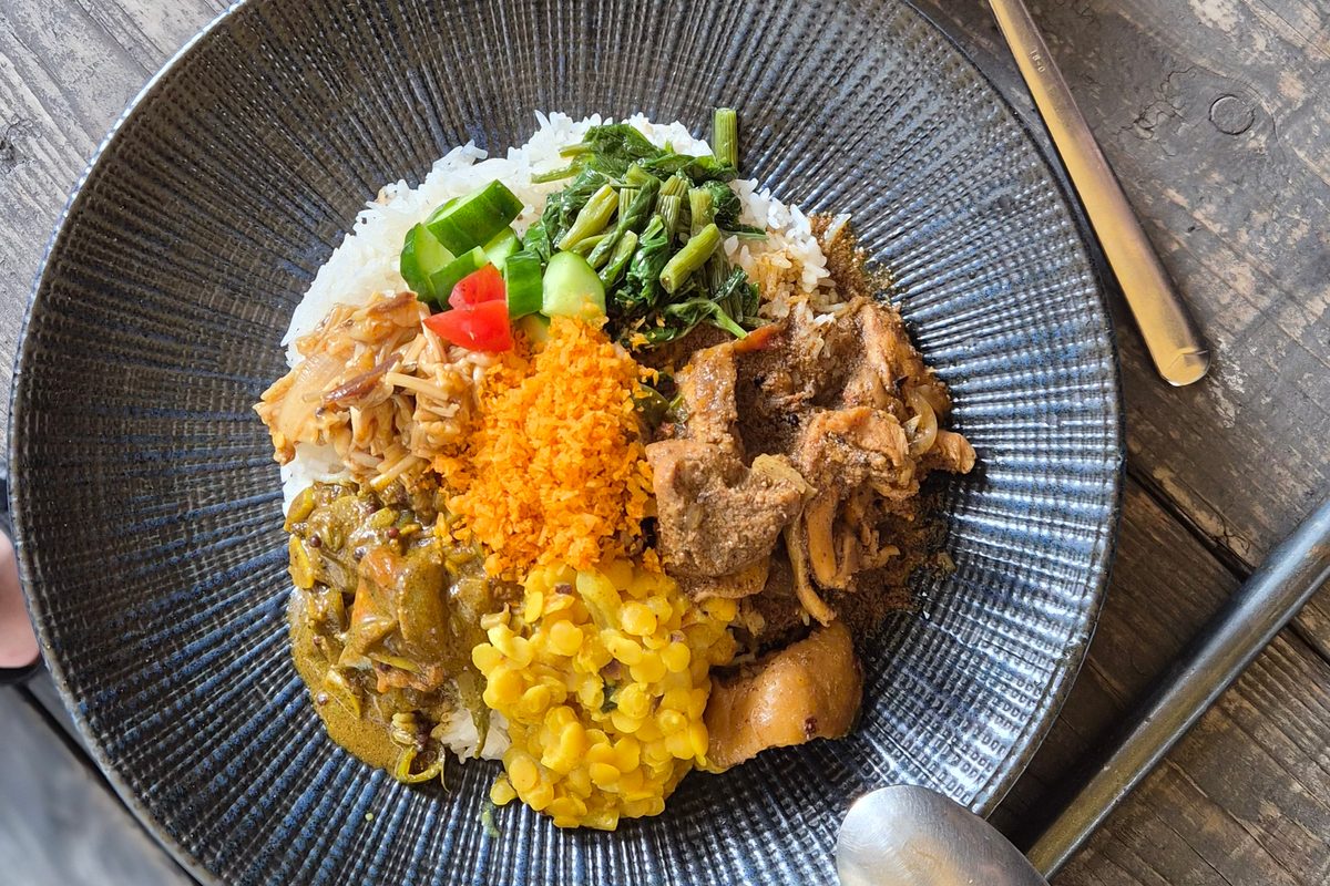 ごはんのまわりにカレーと副菜をたっぷり盛ったプレート